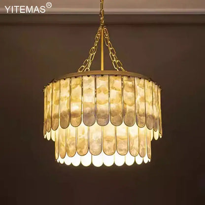 Elegant decorbites gold shell chandelier with layered translucent shell panels in a tiered living room pendant light design
