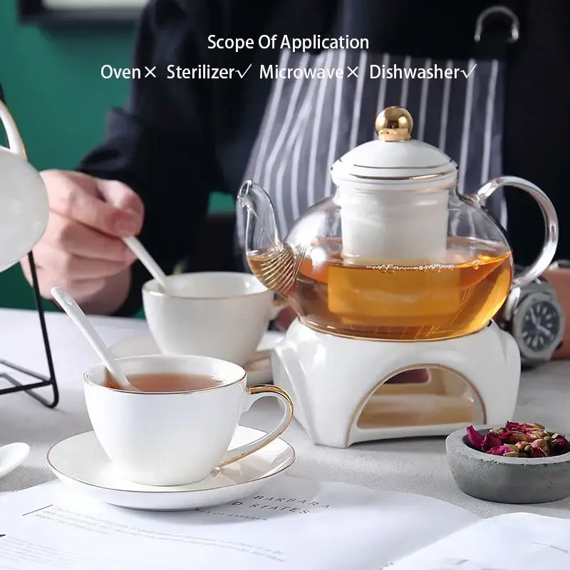 White ceramic tea set with gold trim and glass teapot on integrated heating base decorbites gold white design