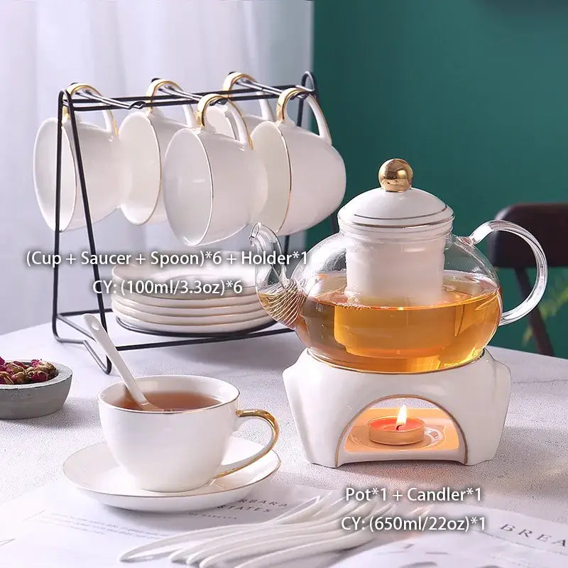 White ceramic tea set featuring a decorbites gold white glass teapot with gold accents on a ceramic warmer with candle