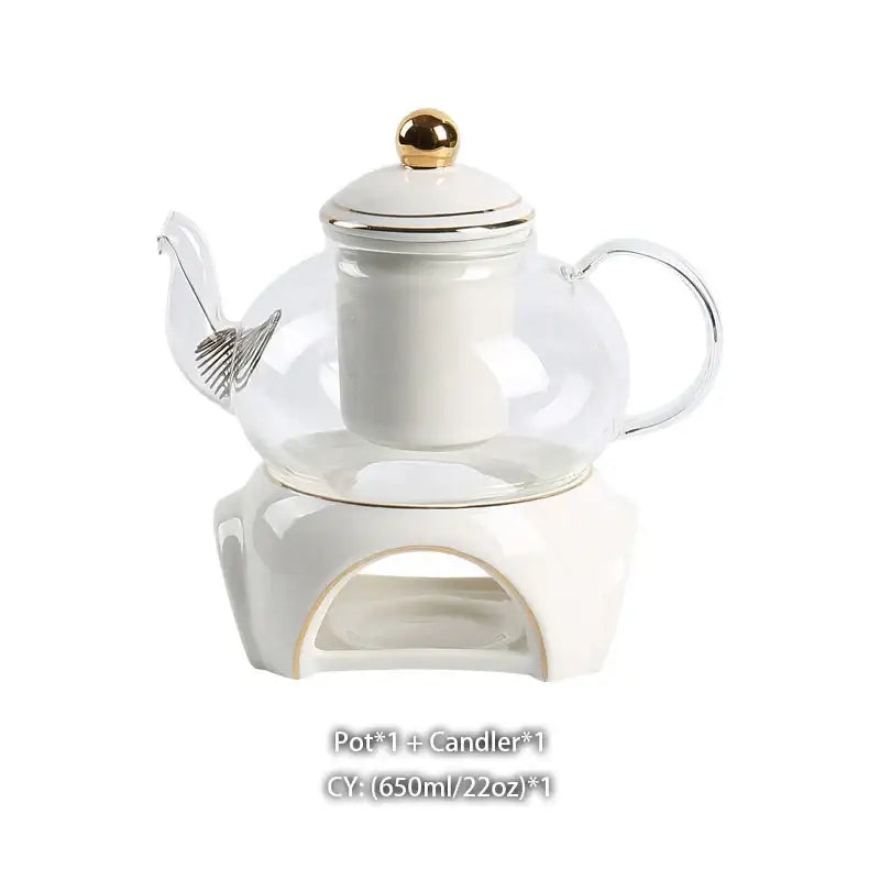 Clear glass teapot with white ceramic infuser and gold lid knob on matching stand from decorbites gold white tea set