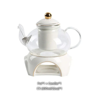 Clear glass teapot with white ceramic infuser and gold lid knob on matching stand from decorbites gold white tea set