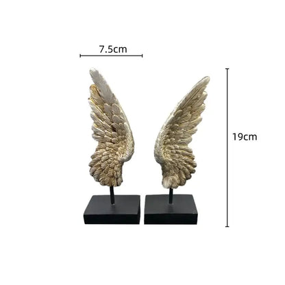 Pair of elegant metallic gold angel wings resin sculptures with detailed feather texture on black square bases for decor