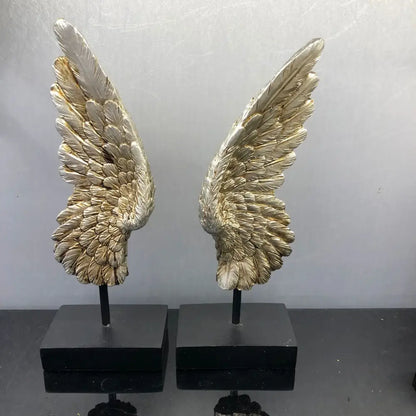 Elegant golden angel wings resin sculpture with detailed feathering mounted on black bases for living room decor
