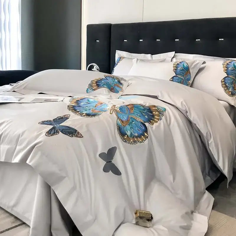Light gray satin bedding set with intricate blue and gold decorbites butterfly embroidery for elegant bedroom decor