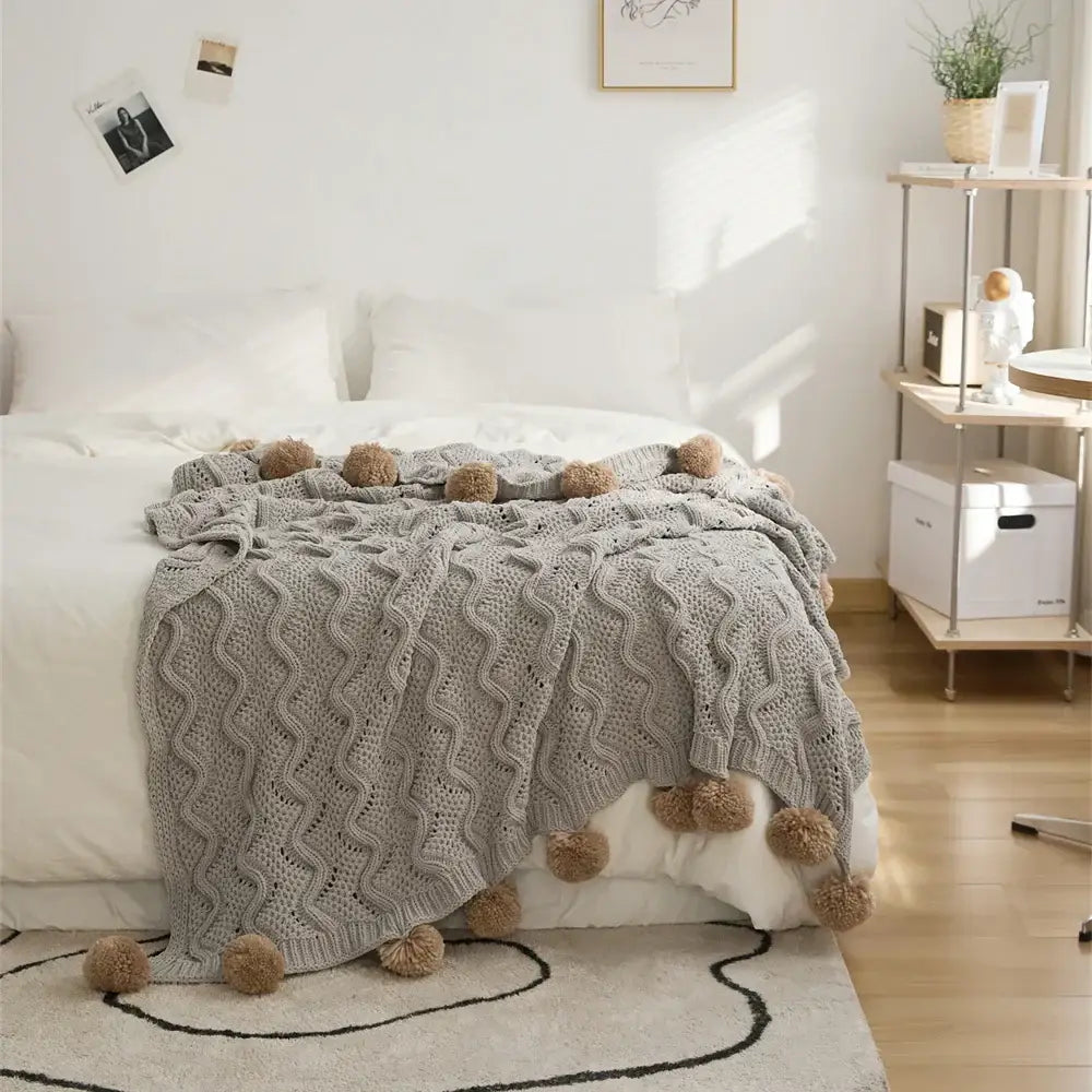 Elegant gray chenille throw blanket with textured wavy pattern and beige decorbites elegant chenille pompons edges