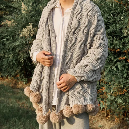 A cozy light gray cable knit cardigan with beige elegant chenille pompons complements decorbites elegant chenille throw blanket
