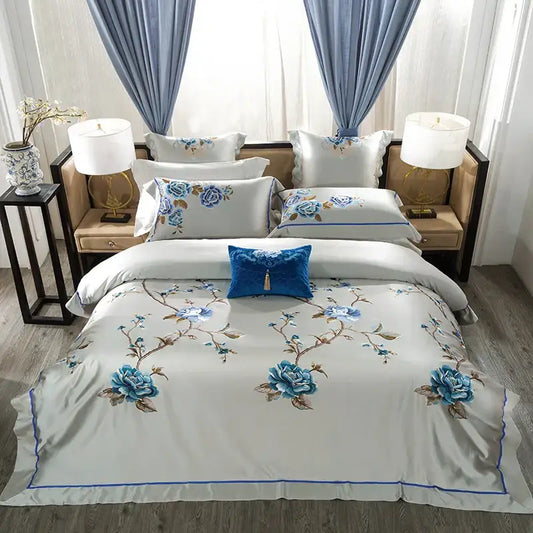 Elegant ivory satin bedding set with intricate blue floral 200s embroidery egyptian cotton and royal blue accent pillows