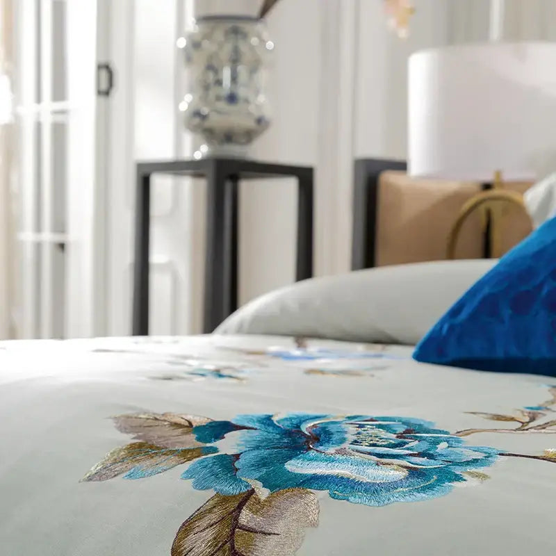 Elegant ivory and royal blue bedding set with intricate 200s embroidery egyptian cotton floral design on cream bedspread