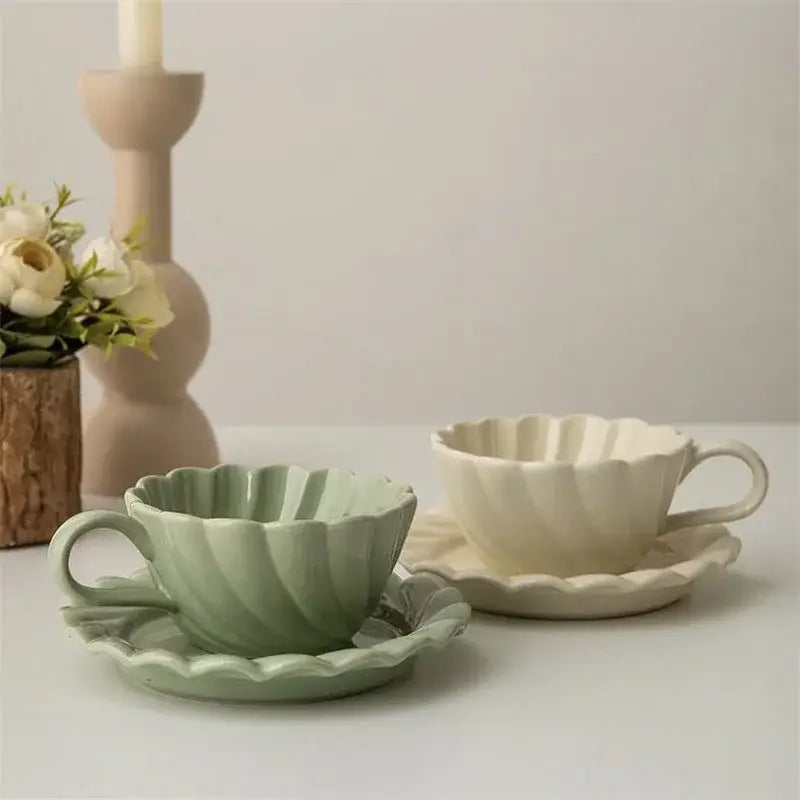 Elegant lace ceramic coffee cup and saucer set in white and mint with scalloped edges and vertical ridges
