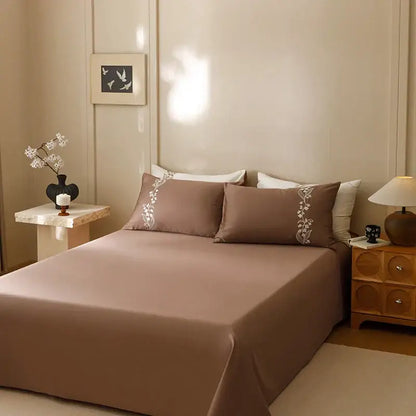 Brown satin cotton bedding set with delicate white floral embroidery on pillowcases from decorbites elegant lily collection
