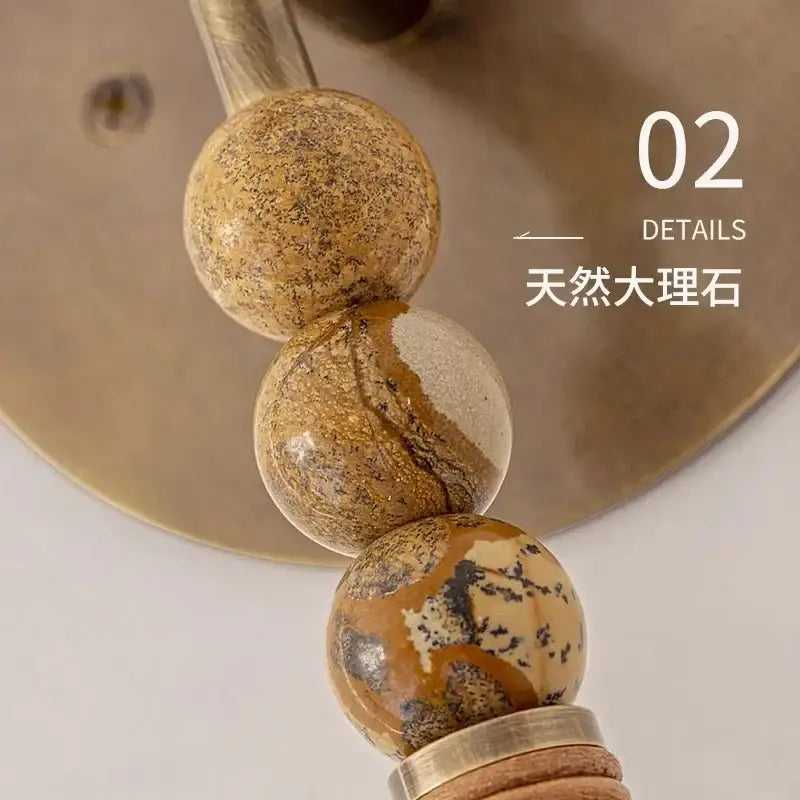 Natural marble beads with earthy brown beige and black veining featured in decorbites elegant marble copper wall lamp