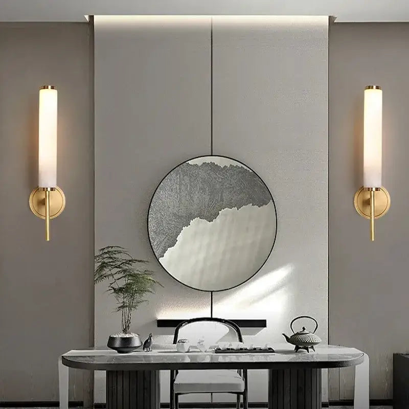 Gold-finished cylindrical wall sconce with frosted glass shade from decorbites elegant marble copper bedroom lighting
