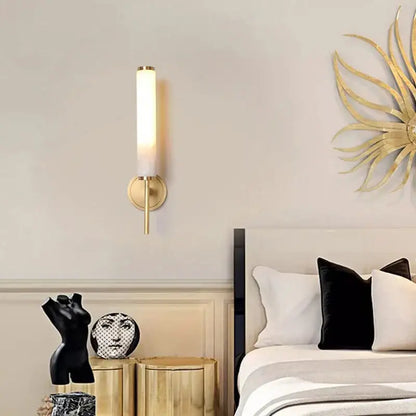 Elegant marble copper wall sconce with gold-toned cylindrical design and frosted glass shade for bedroom lighting decorbites elegant marble