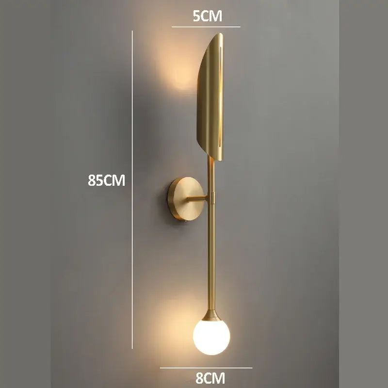 Elegant modern wall lamp gold-toned with sleek elongated leaf design and frosted glass bulb for bedroom decorbites elegant modern