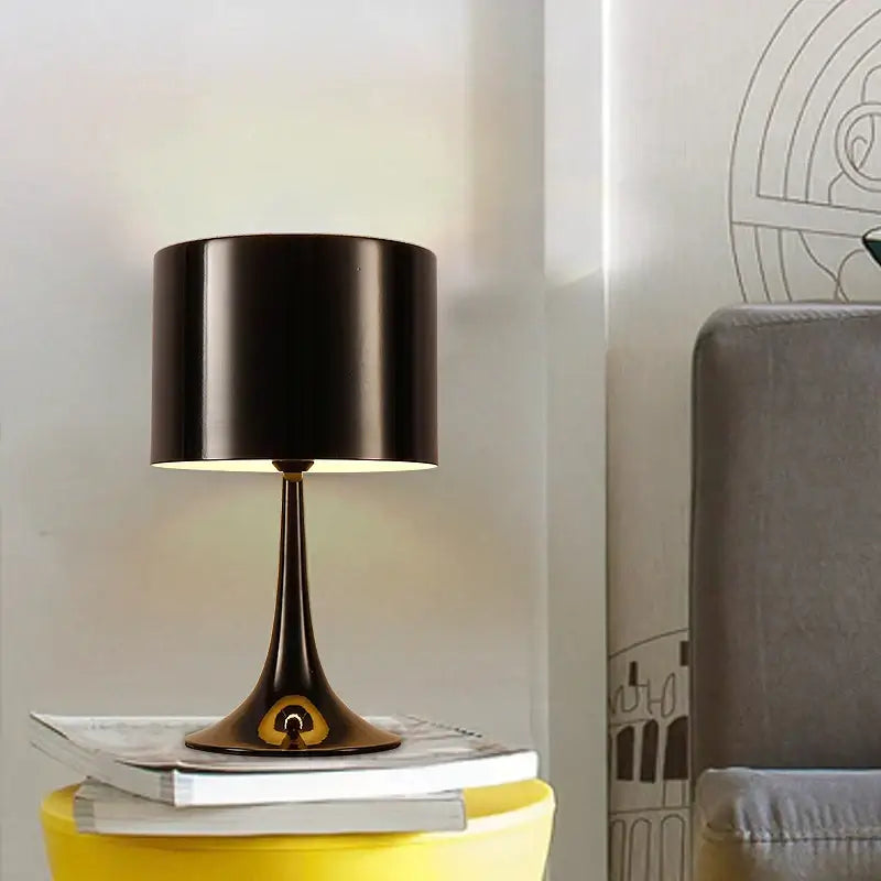 Elegant mushroom floor lamp with black cylindrical shade, sleek metallic base, and gold accent for warm living room decorbites