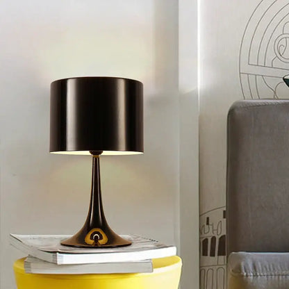 Elegant mushroom floor lamp with black cylindrical shade, sleek metallic base, and gold accent for warm living room decorbites