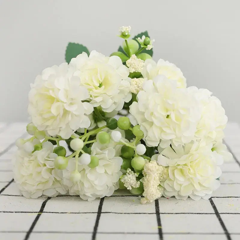 Delicate artificial white hydrangeas with green berries and leaves in an elegant pink decorbites daisy bouquet for living room decor