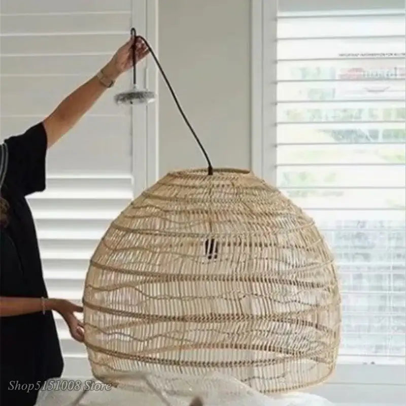 Natural woven rattan pendant light with beige-brown basketweave and black cord from Decorbites elegant rattan wave series
