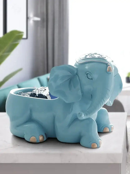 Elegant resin deer key holder featuring a turquoise ceramic elephant design with gold-tipped feet and silver headpiece decorbites