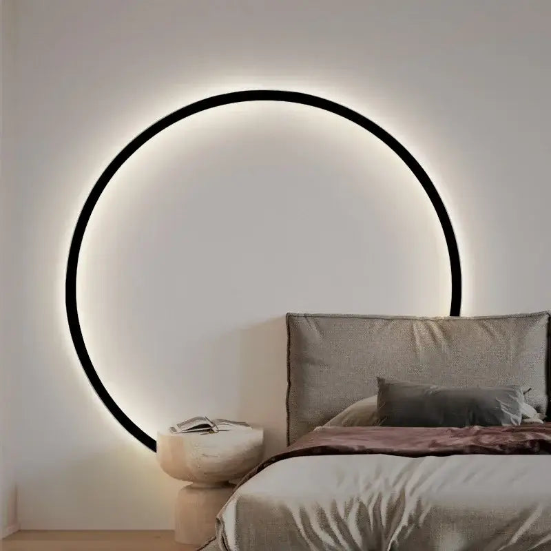 A sleek black circular led wall sconce with glowing white illumination decorbites elegant round wall lighting for indoor use