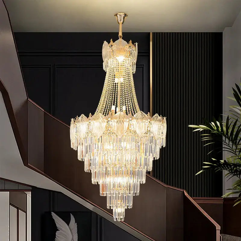 Multi-tiered crystal chandelier with gold-toned metal frame and clear glass prisms for elegant simple staircase decorbites