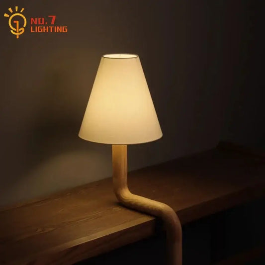 Warm-toned decorbites elegant solid wood table lamp with curved wooden base and off-white fabric shade for bedroom decor