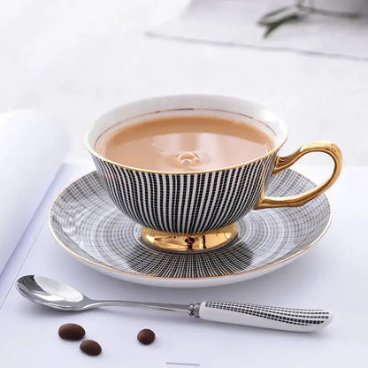 Elegant black and white striped porcelain tea cup with gold trim filled with tea from a tea cup set
