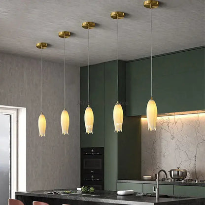 Five warm-toned decorbites elegant tulip pendant lights with gold fixtures and frosted glass shades for staircase decor