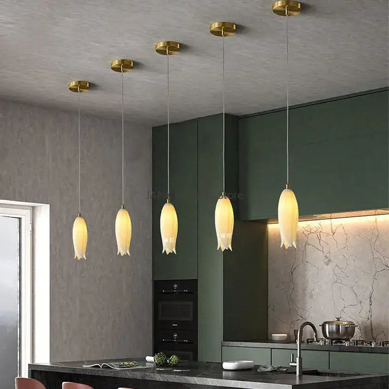 Five warm-toned decorbites elegant tulip pendant lights with gold fixtures and frosted glass shades for staircase decor