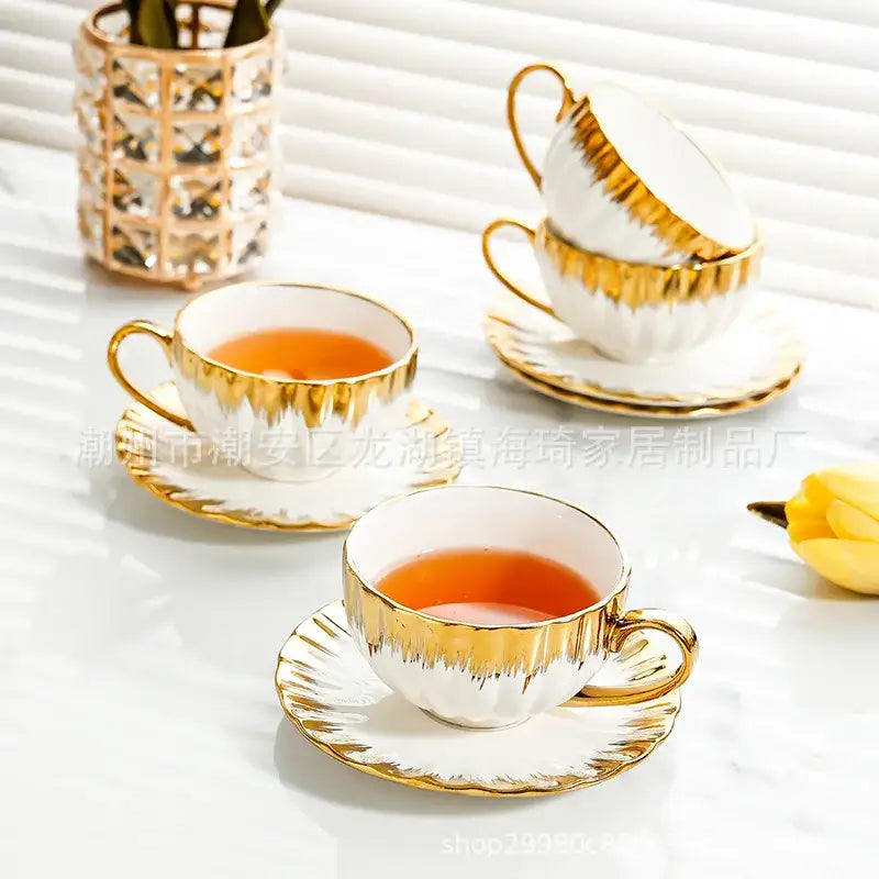 Elegant white and golden ceramic tea cup set with gold-trimmed rims and handles for decorbites golden ceramic collection
