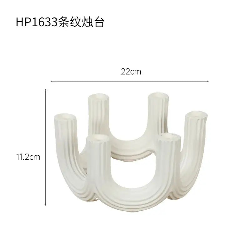 Elegant white ceramic candlestick holder with vertical ribbed texture and curved u-shaped design for dining room decorbites decor
