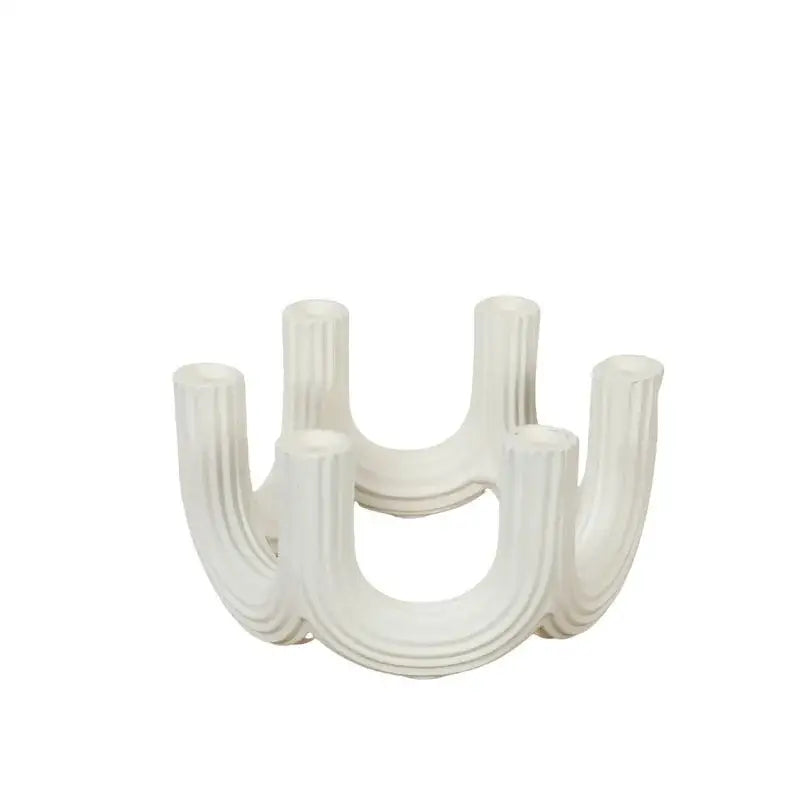 Elegant white ceramic candlestick holder with modern curved design and vertical ridges for dining room decorbites elegant white decor