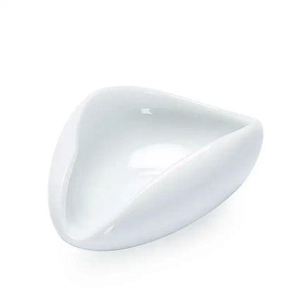 A sleek glossy white ceramic dose tray with a modern triangular design for decorbites ceramic white tea spoon set