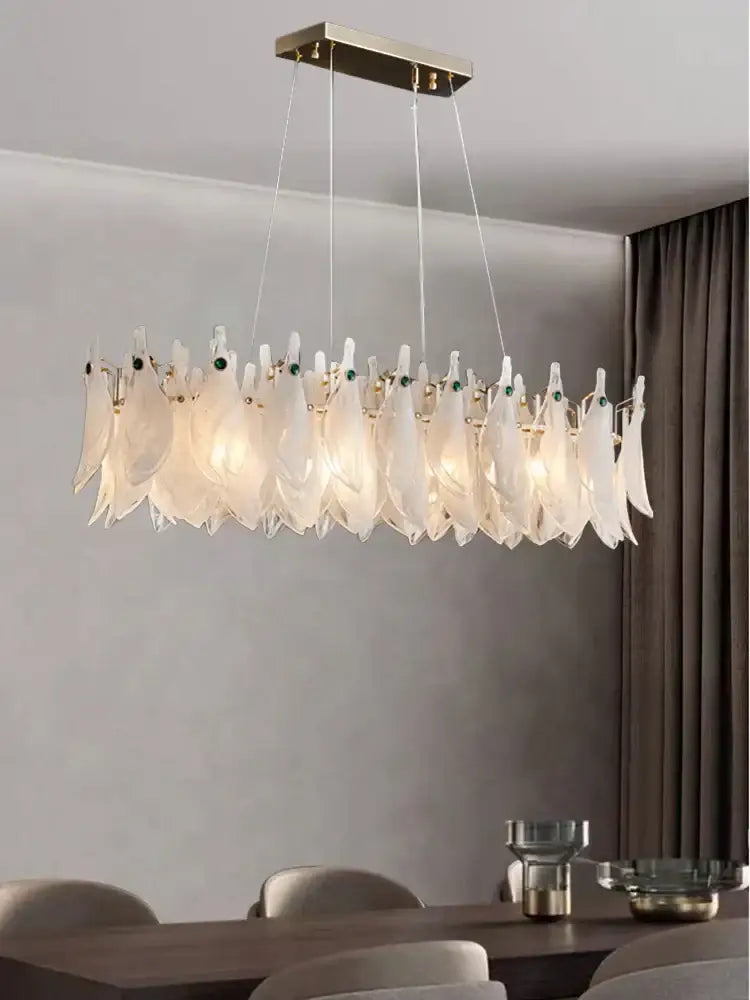 Modern chandelier with feather-like design in a room setting