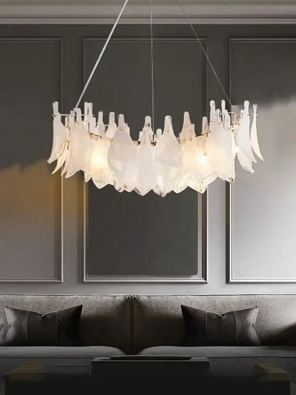 Elegant white feather cloud mist glass chandelier with modern leaf-like design hanging above sofa decorbites cloud mist