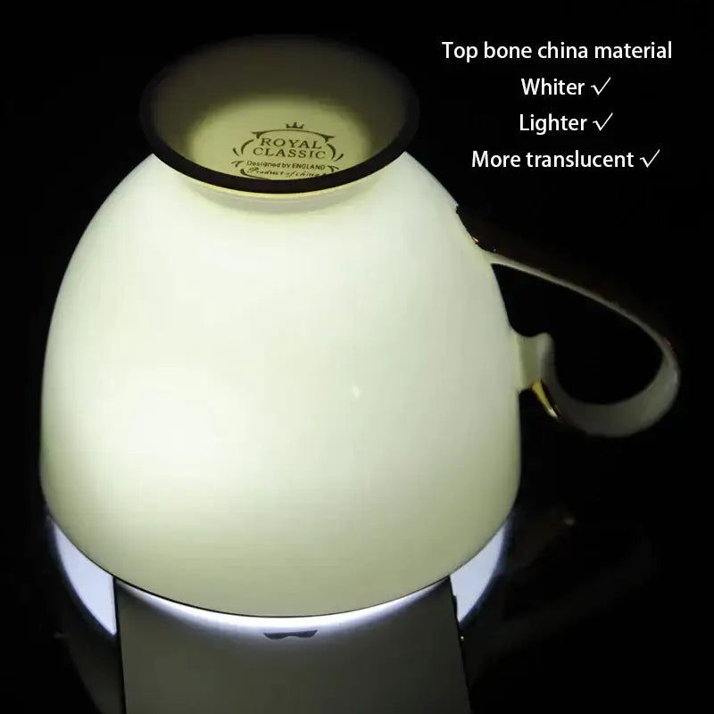 A creamy white bone china coffee set teacup with black rim gold handle featuring royal classic logo