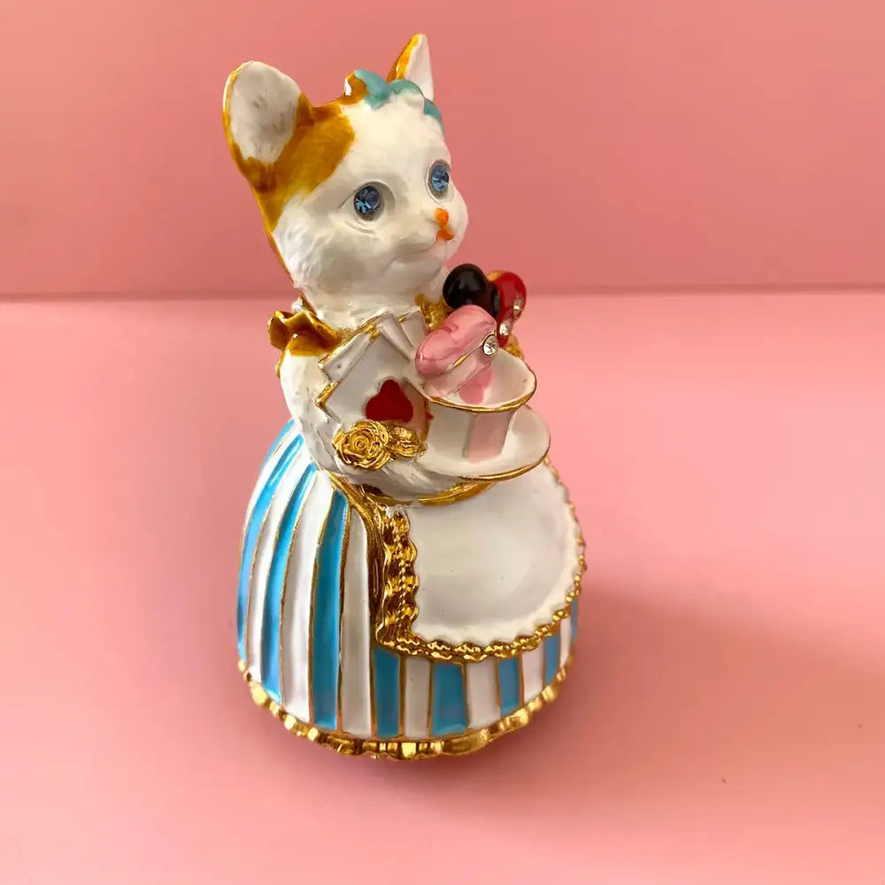 Elegant white porcelain cat trinket box dressed in blue striped gown holding heart-decorated teacup for bedroom decor