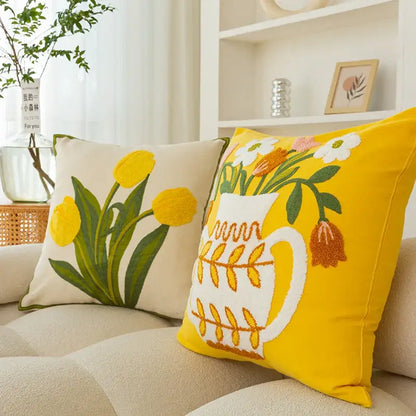 Bright yellow cushion cover with embroidered vase flower design featuring a white pitcher and colorful blooms decorbites elegant yellow