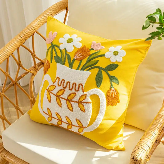 Bright yellow cushion cover with white embroidered vase flower design featuring colorful flowers and green leaves decorbites elegant yellow