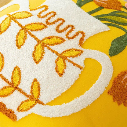 A plush white embroidered cushion cover with golden-yellow vase flower design on vibrant yellow decorbites elegant yellow background