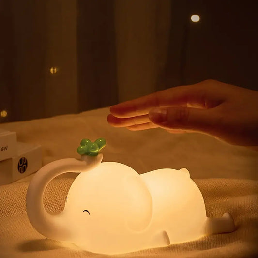 Soft white elephant silicone night light with a green clover glowing warmly for bedroom decorbites elephant silicone decor
