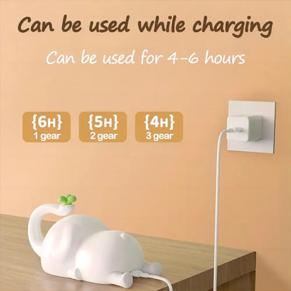 White plastic cat-shaped phone charger with green leaf detail accompanying decorbites elephant silicone night light bedroom decor