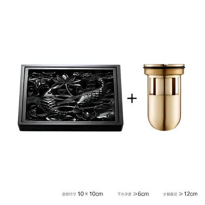Black brass square floor drain with embossed lotus and fish design paired with gold-toned water filter for shower room