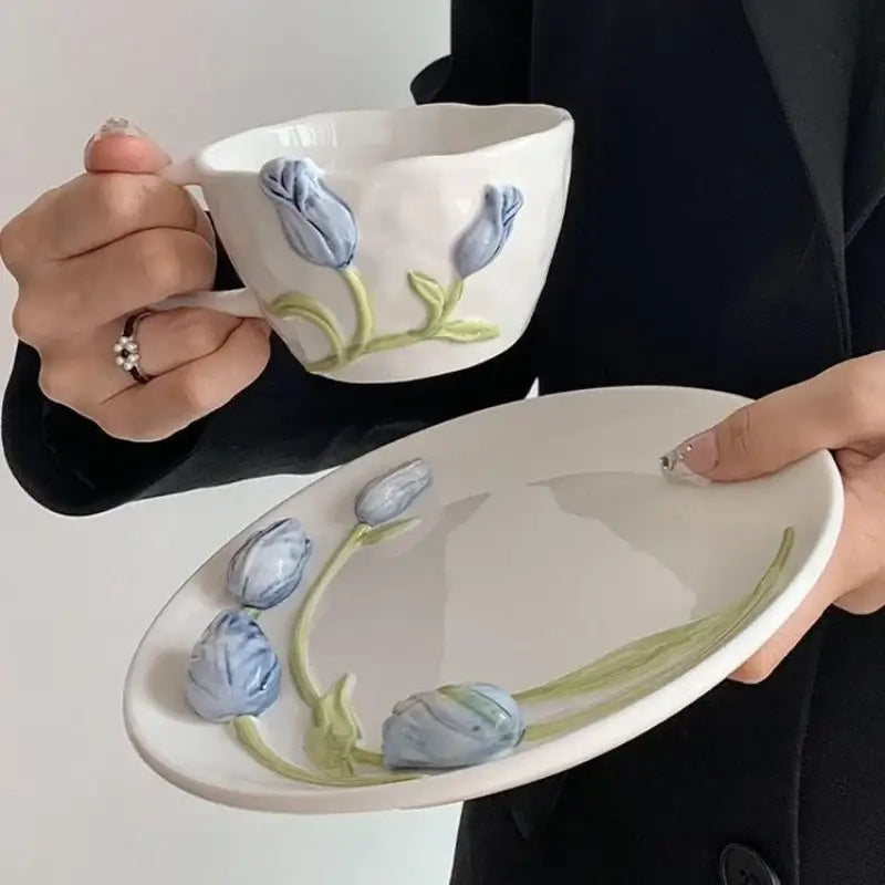 White ceramic embossed tulip ceramic cup and matching oval plate with raised blue tulips and green stems decorbites 3d embossed