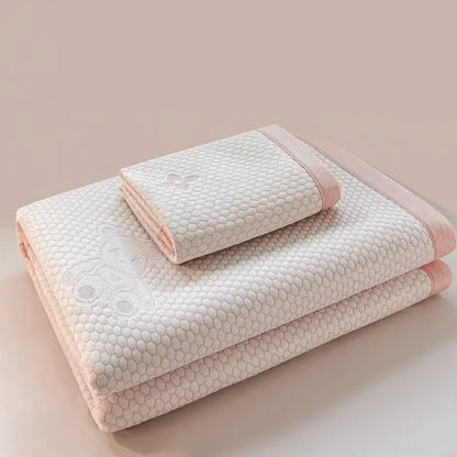 Soft off-white quilted cooling feel mat set with honeycomb texture and pink piping for bedroom mattress use