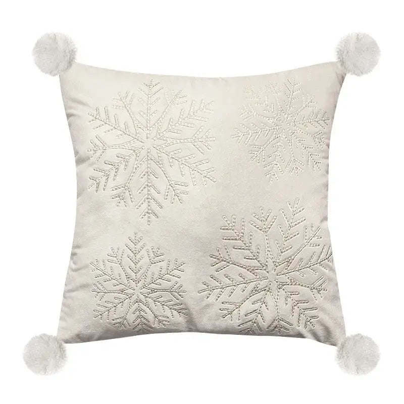 Cream-colored pillow cover with silver embroidered snowflakes and white pom-poms for decorbites embroidered christmas pillow decor