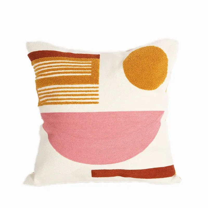 Cream-colored embroidered cushion cover with textured geometric patterns in mustard yellow dusty rose and terracotta brown