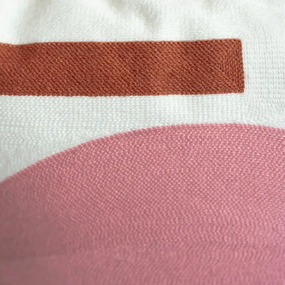 Embroidered cushion cover set featuring soft white fabric with rust stripe and curved pink section for living room decor
