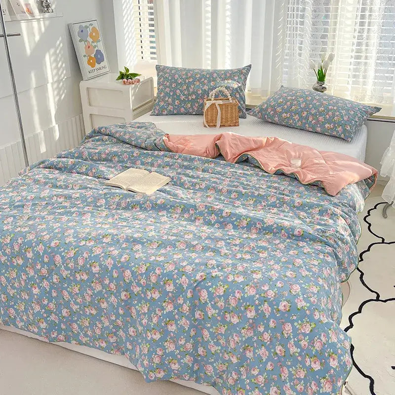 Embroidered double gauze rabbit print quilt comforter in blue with pink roses and green leaves on soft textured fabric