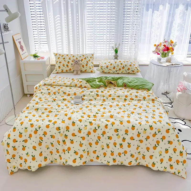Cream-colored double gauze rabbit print quilt with orange fruits and green leaves in soft textured fabric finish